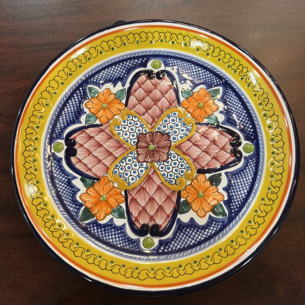 This authentic Mexican Talavera plate features hand-painted, vibrant floral